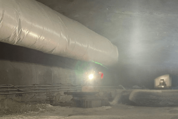 Large underground tunnel under construction with ventilation control systems in place
