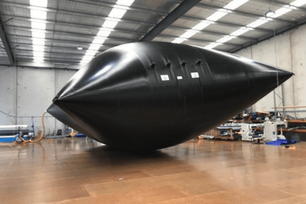 Effluent storage bladder tank is being leak tested at a factory by blowing up with pressurised air 