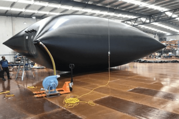 flexible liquid storage bladder is being tested in a factory by blowing up with pressurised air 
